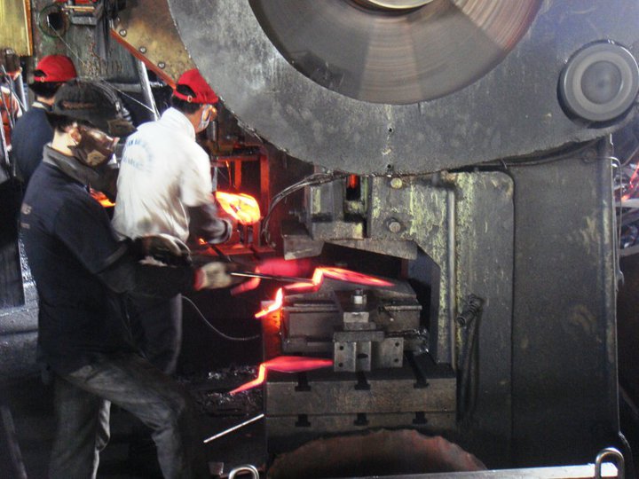 A factory worker forging a trowel blade in Taichung, Taiwan.
